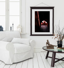 Laden Sie das Bild in den Galerie-Viewer, Bronze black male figure sculpture Eric sits on a table in a light colored living room.  A print of the drawing Light in the Tunnel of the pastel drawing series of Passages ~Morocco is seen on the wall home decor.
