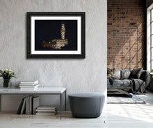 Load image into Gallery viewer, Palazzo Vecchio at Night, a pastel drawing on black paper inspired by the City Hall architecture in Florence, Italy, is shown here is mockup wide, dark frame with white mat. the art is hung in a loft apartment for a blend of old and new.
