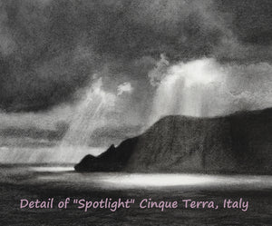 Detail of Spotlight, an original charcoal drawing of the rugged Italian coastline before a storm.  The dark clouds part just enough to allow sun rays to shine down from the heavens and into the sea.  Art by Kelly Borsheim