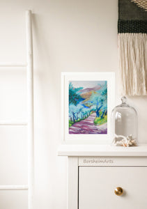 Tuscan Road in Shadows Pastel Art shown with white frame and white mat.  The art rests against a wall as it sits on the top of a dresser in this boho bedroom scene.