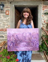 Cargar imagen en el visor de la galería, The artist Kelly Borsheim holds her painting Vineyard in Fog Montecarlo Tuscany for photographer Jane Sulicich, outside of her Tuscan home.

