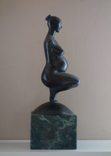 Laden Sie das Bild in den Galerie-Viewer, Profile view of Pregnancy, a female pregnant mamma squatting with legs together in a graceful, elegant pose, bronze figure statue, mounted on a green marble base, tabletop sculpture by Vasily Fedorouk, Ukrainian - American sculptor artist
