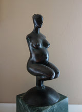 Load image into Gallery viewer, woman without arms and with hair in a bun, Pregnancy, a female pregnant mamma squatting with legs together in a graceful, elegant pose, bronze figure statue, mounted on a green marble base, tabletop sculpture by Vasily Fedorouk, Ukrainian - American sculptor artist
