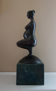 Other profile of maternity sculpture, Pregnancy, a female pregnant mamma squatting with legs together in a graceful, elegant pose, bronze figure statue, mounted on a green marble base, tabletop sculpture by Vasily Fedorouk, Ukrainian - American sculptor artist