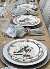 Laden Sie das Bild in den Galerie-Viewer, These gorgeous designer plates, the Tiger Shoe Circus by Dragana Adamov, bring a unique elegance to this table setting.
