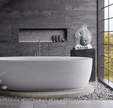 Load image into Gallery viewer, Mock-up of marble sculpture Yin Yang in an elegant  bathroom with grey stone tile, making a lovely background for a white marble sculpture by Kelly Borsheim
