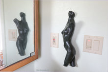Charger l&#39;image dans la galerie, Here the Dancer bronze nude torso of a ballerina is shown hung on a bathroom wall and reflected in the mirror for double enjoyment.  Patina is the dark green finish here.
