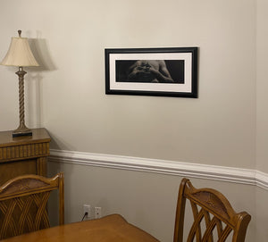 Add elegance to any room with Entwined, framed charcoal drawing of man with interlaced fingers, as it might look in a dining room as home decor art