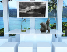 Load image into Gallery viewer, Conference room with large windows overlooking water, or family dining room, with stone sculpture Fish Lips, bronze sculpture Cattails and Frog Legs, and a print of charcoal drawing Spotlight, the sun rays peeking through clouds on Italian coastline, live with art
