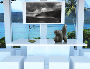 Conference room with large windows overlooking water, or family dining room, with stone sculpture Fish Lips, bronze sculpture Cattails and Frog Legs, and a print of charcoal drawing Spotlight, the sun rays peeking through clouds on Italian coastline, live with art