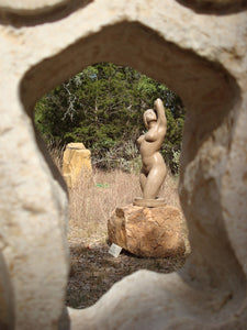 this artistic photo uses the hole of another sculpture to frame the bronze statue Gemini... ooh la la !  