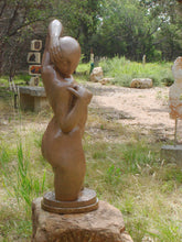 Load image into Gallery viewer, View of the face that looks down to the female figure&#39;s right side. Gemini Bronze Garden Sculpture Voluptuous Abstract Figure Statue with Two Faces shown in a sculpture garden in Dripping Springs, Texas
