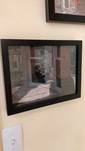 Pastel painting of young woman reading outside in winter under Italian architecture in Piazza Ciompi in Florence, Italy.  Artwork shown hung on the wall near another framed art piece.