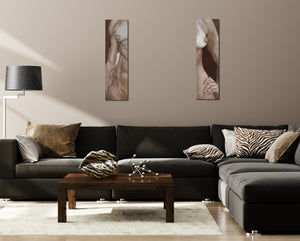 a male and a female torso, painted on two separate canvases look great on this living room wall above a dark couch, shown with Zebra Lips on the coffee table, a marble sculpture by artist Kelly Borsheim