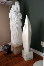 Load image into Gallery viewer, Shown here in a living room to show actual size is Birth of Beauty, three human figures in marble.  Beside that artwork is &quot;Fire Dance,&quot; a lovely flame-shaped white marble sculpture with bas-relief figures by Vasily Fedorouk
