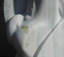 Load image into Gallery viewer, Detail of the pale green yellow gems inside the white Colorado Yule Marble sculpture Yin Yang by Kelly Borsheim
