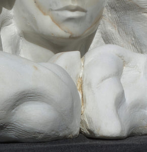 Detail of the crack in the marble that separates the hair forms where they meet.  Serenity marble portrait of a woman by Kelly Borsheim