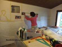 Load image into Gallery viewer, Artist Kelly Borsheim enlarges her mural design on the wall.
