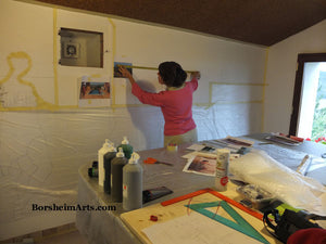Artist Kelly Borsheim enlarges her mural design on the wall.