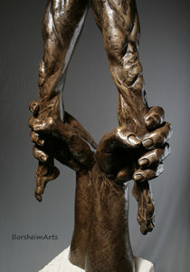 Detail of larger than life hands compared to the 24 inch male nude figure.  The large pair of hands are pulling down the man, trying to stop him.  It represents challenges and obstacles.