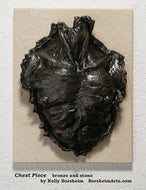 small wall hanging bronze Chest Piece Male Nude Bronze Bas Relief of man's check with textured edges, mounted on a travertine cream stone tile