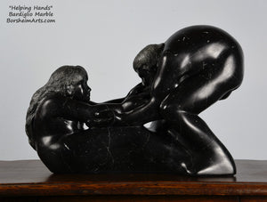 Helping Hands by Kelly Borsheim Couple Art Carved from a black marble called Bardiglio from Italy, this sculpture depicts a man bending over forward to help a seated woman stand up.  Her hands reach up towards his bearded face, but it is the moment before she is close enough to reach him. 