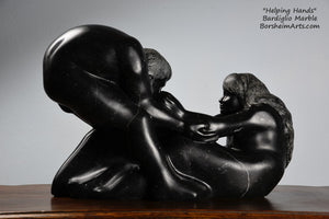 Helping Hands by Kelly Borsheim Couple Art Carved from a black marble called Bardiglio from Italy, this sculpture depicts a man bending over forward to help a seated woman stand up.  Her hands reach up towards his bearded face, but it is the moment before she is close enough to reach him. 