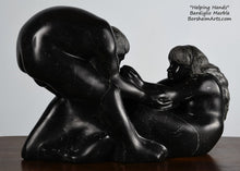 Load image into Gallery viewer, note the space between the woman&#39;s hand and his face Helping Hands by Kelly Borsheim Couple Art Carved from a black marble called Bardiglio from Italy, this sculpture depicts a man bending over forward to help a seated woman stand up.  Her hands reach up towards his bearded face, but it is the moment before she is close enough to reach him. 
