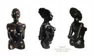 terra-cotta sculpture of a black woman with her hair pulled back into a large bun.  She stands tall and proud, her posture is slightly arched back with her arms folded together behind her, a beautiful physique