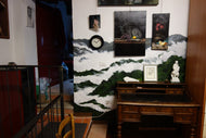 Mural in private home to create a dark background against two white marble sculptures.  Painted clouds floating among green wooded hills in Tuscany, Italy.  by Artist Kelly Borsheim