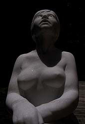 Full moon lit Stargazer Garden Marble Sculpture of seated Woman resting hands on a knee while leaning back to look up to the skies and stars.