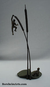 Whole view of tabletop sculpture statues of two men with lily pad and two cattails.  Life is so uncertain!  Thanks Lyle Lovett for those words. Artist Kelly Borsheim bronze art