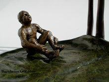 Load image into Gallery viewer, Detail of man sitting and leaning back to look up to the other man.  This image shows the lovely green patina with rings for subtle texture on the giant (to him) lily pad bronze sculpture

